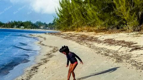 Girl Playing in Sand At Sandy Point Beach With Blue Sky In Abaco The Bahamas 19