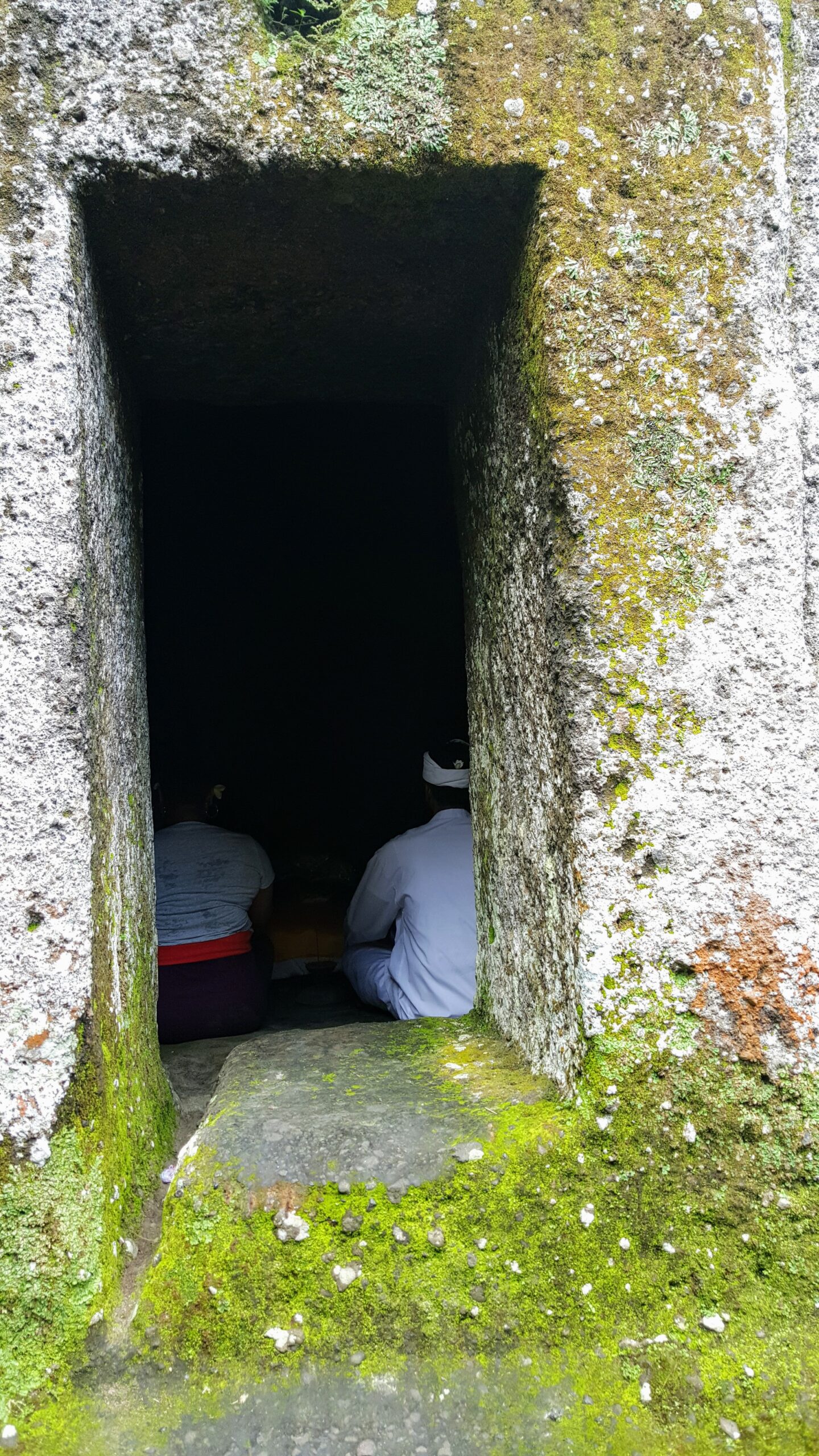 Meditation in a cave led by a guide as part of a spiritual tour in Bali. Meditation in a Cave - I traveled to the Gunung Kawi Temple complex, a collection of ancient shrines, carved into the face of a rock cliff that overlooks the sacred Pakerisan River in Bali.