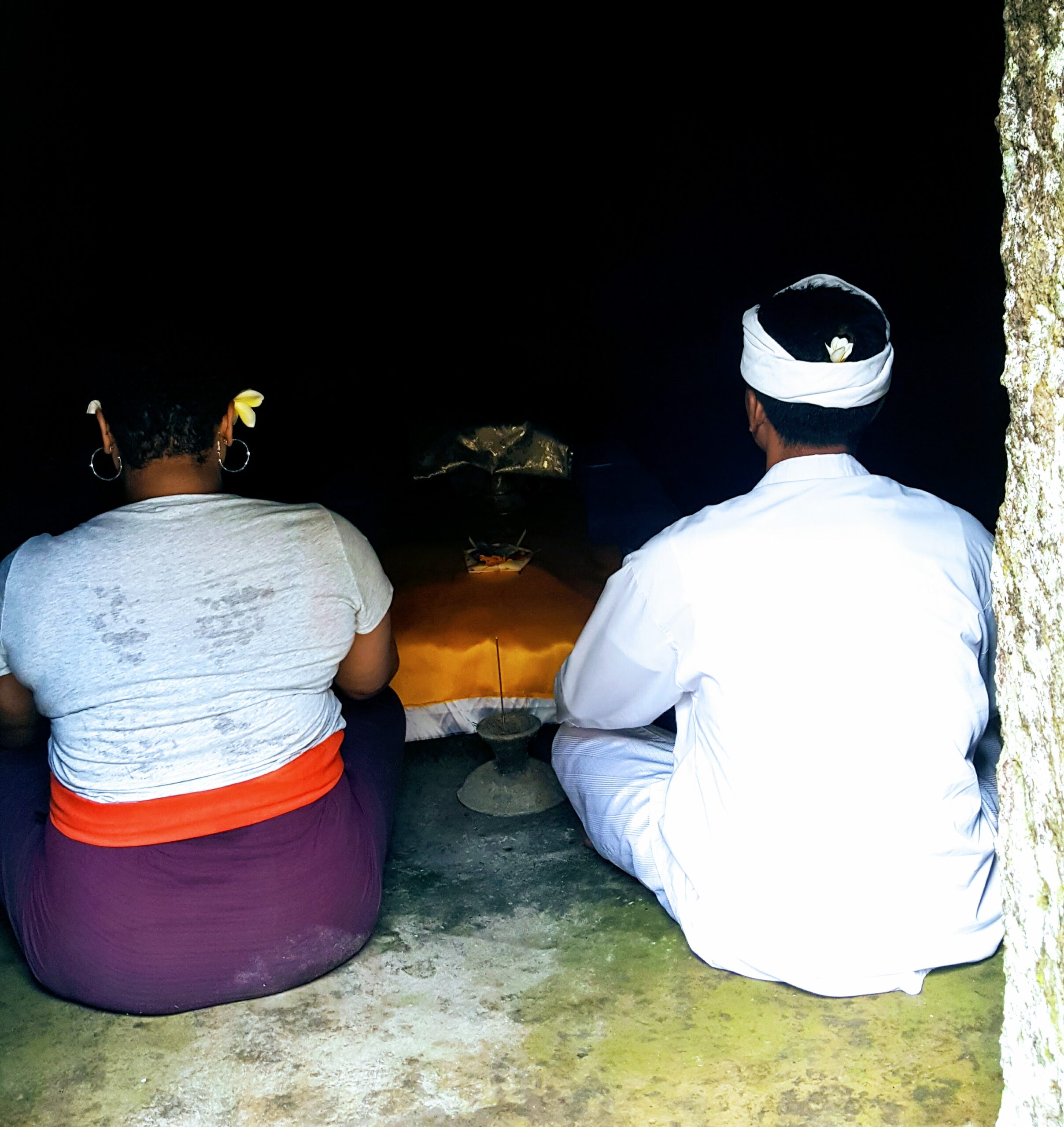 Meditation in a cave led by a guide as part of a spiritual tour in Bali. Meditation in a Cave - I traveled to the Gunung Kawi Temple complex, a collection of ancient shrines, carved into the face of a rock cliff that overlooks the sacred Pakerisan River in Bali.
