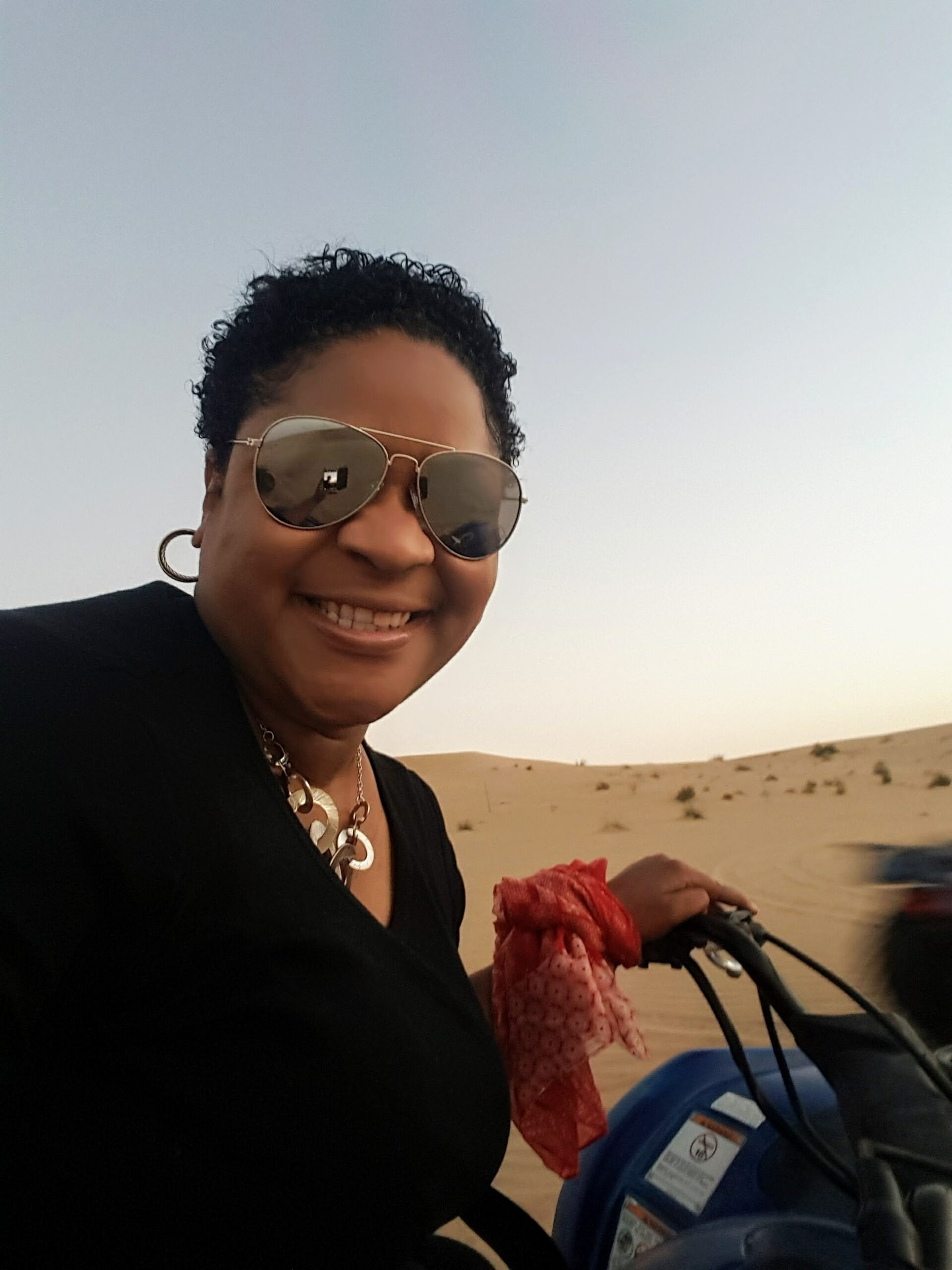 Mei Photos riding an ATV in the desert - Download the best high res Asian and Caribbean stock images for travel, tourism, social media, digital marketing, and photography.