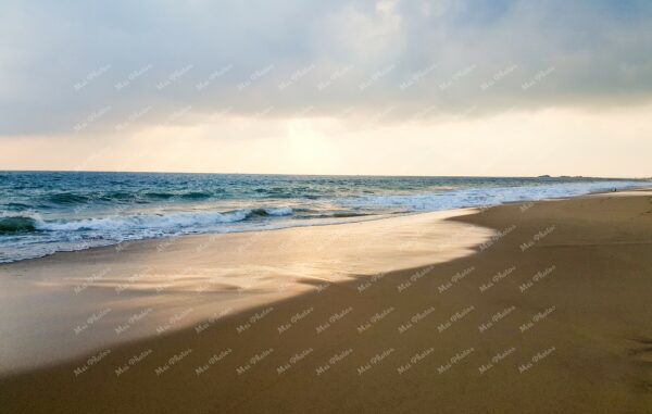 Sand And Waves During Sunset Under Cloudy Sky At Beach In Hikkaduwa Sri Lanka